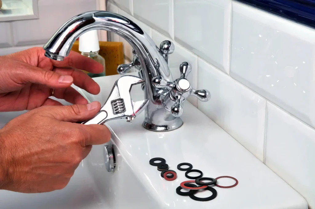 Plumber performing maintenance on a bathroom faucet in Rancho Cucamonga