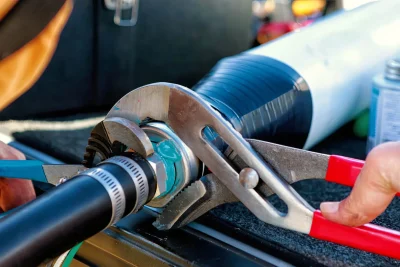 Technician tightening an industrial pipe connection in Rancho Cucamonga