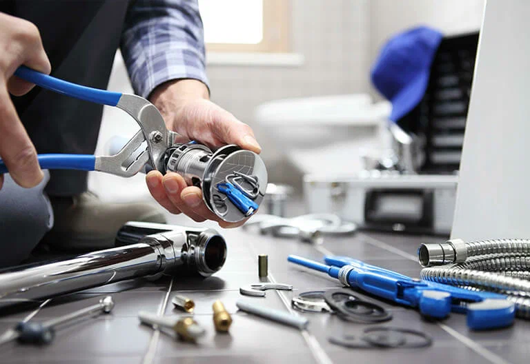 Technician repairing a plumbing fixture with professional tools in Rancho Cucamonga