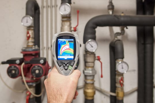 Plumber using a thermal imaging camera to inspect pipes in Rancho Cucamonga