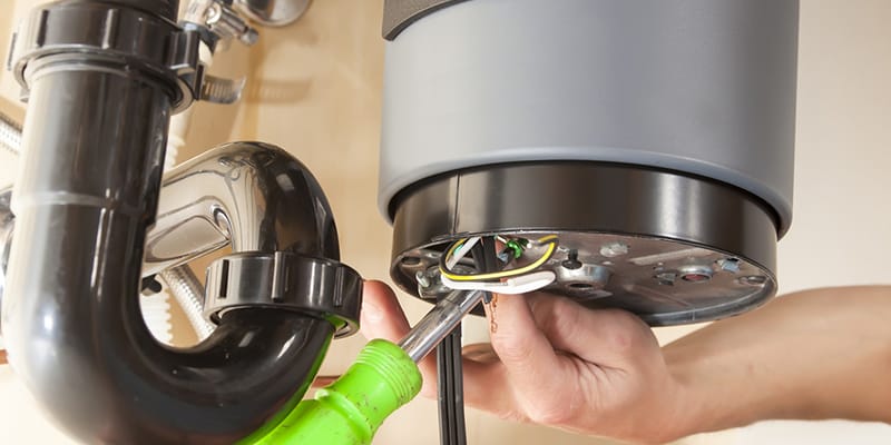 Technician repairing the heating element of a water heater in Rancho Cucamonga