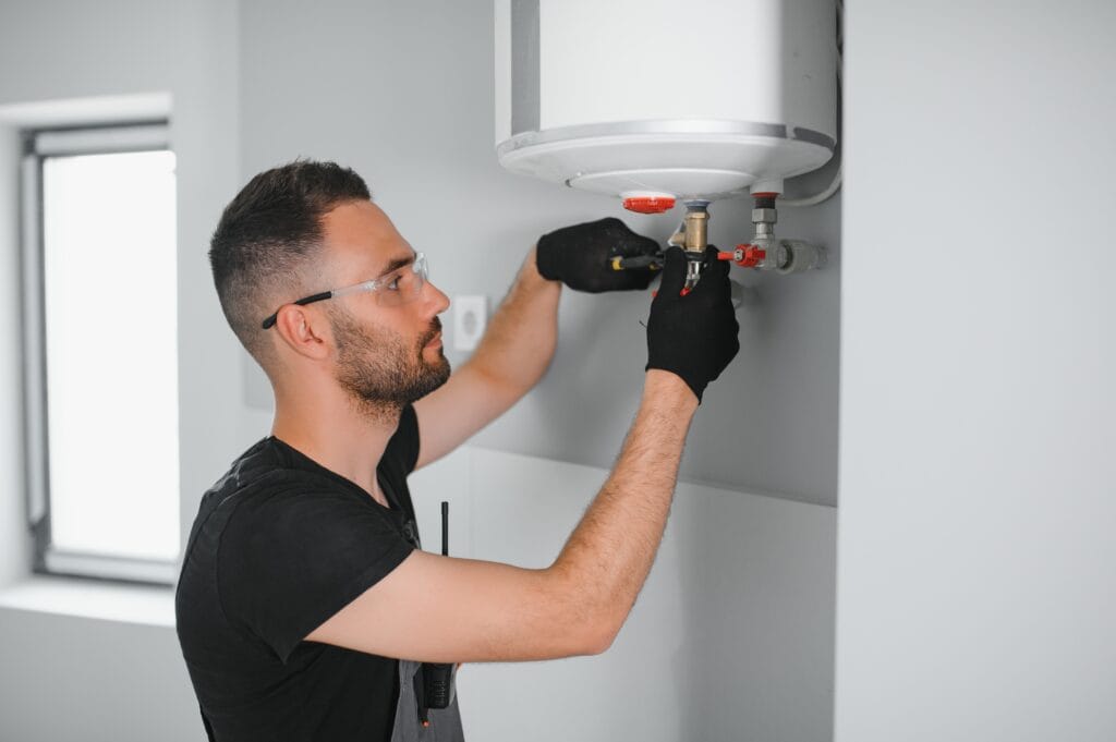 Technician performing water heater maintenance in Rancho Cucamonga