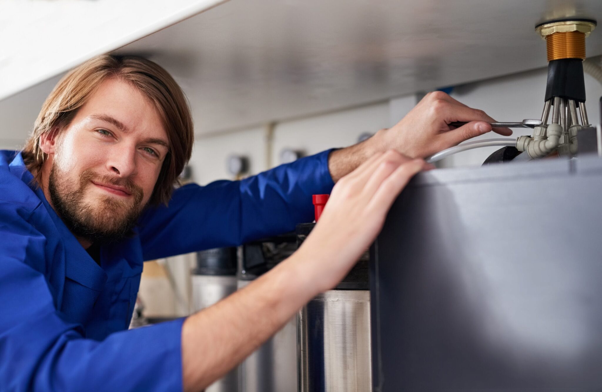 Technician servicing a residential water heater tank in Rancho Cucamonga
