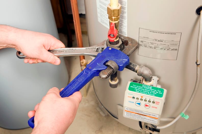Plumber repairing a water heater valve in Rancho Cucamonga